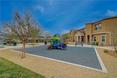 Communal playground featuring a lawn and a residen