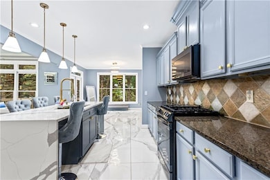 Kitchen with decorative backsplash, crown molding,