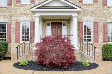 Elegant portico entry with dual staircases