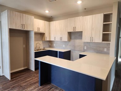 Kitchen with a sink, open shelves, a peninsula, d