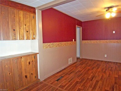 The dining room has laminate flooring and a butler