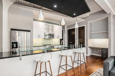 Kitchen featuring pendant lighting, dark hardwood 