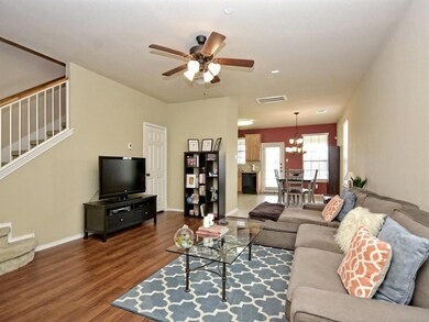 Living room with visible vents, wood finished flo