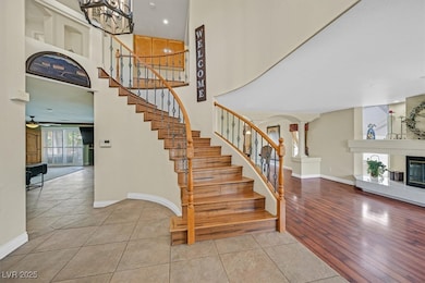 Staircase with baseboards, a chandelier, a large f