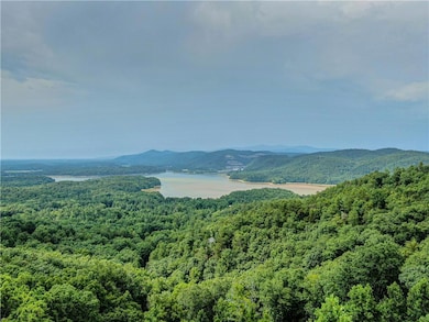 View of mountain background with a nearby body of water and a forest