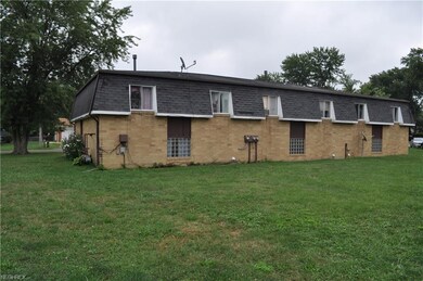 back view of triplex with plenty of parking