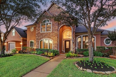 Handsome stucco exterior with added landscape lighting in the front yard provide such curb appeal.