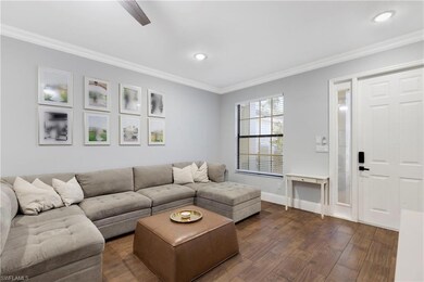 The spacious living room featured crown moulding a