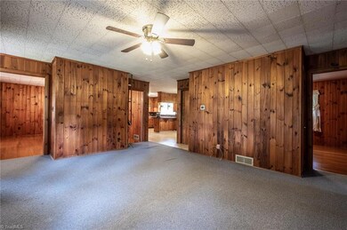 Spacious living room opens to dining room to the left and kitchen.