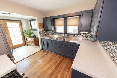 The kitchen features newer range and refrigerator, painted cabinetry and a light filled addition which can serve as a mudroom or accommodate a kitchen table.