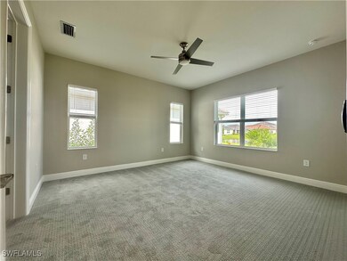 Carpeted spare room featuring ceiling fan
