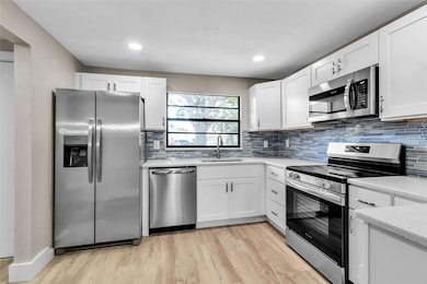 THE WELL PLANNED KITCHEN OFFERS STORAGE AND PLENTY OF WORK ROOM-