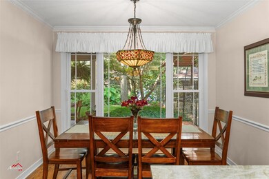 Dining area featuring ornamental molding and hardw