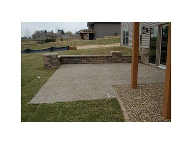Exterior Back. Exposed Aggregate Patio with a deco