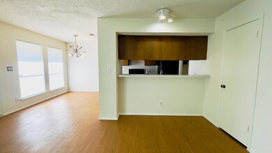 Kitchen with wood finished floors, refrigerator, 