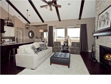Beamed great room ceiling with natural light via t