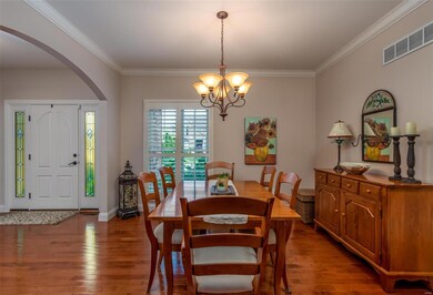 Dining Room with arched doorways and plantation shutters