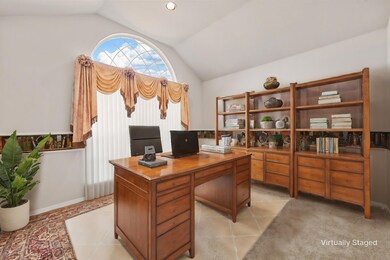 Office featuring light carpet and vaulted ceiling