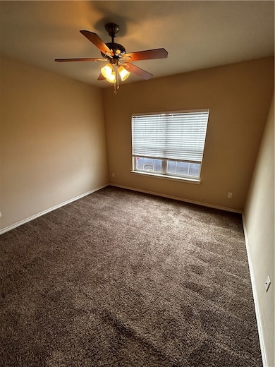 Empty room featuring carpet floors and a ceiling f