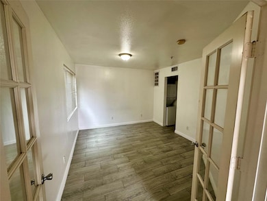 Unfurnished room featuring visible vents, baseboar