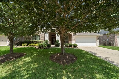 View of the home framed by lush mature trees provi