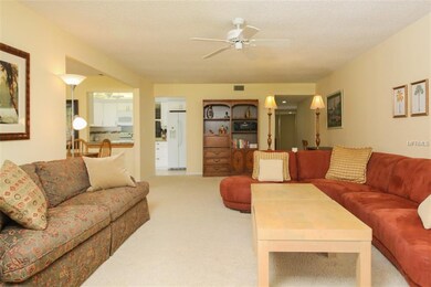 Living room with high ceilings looking back to din