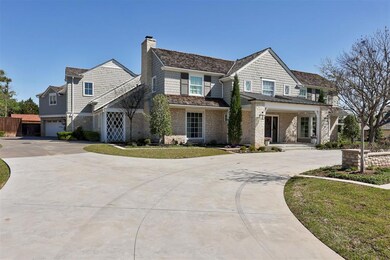 View of front of home with a front yard and a gara