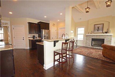 Check out this kitchen! A Chef's dream! Granite counter tops, hardwood floors and stools for everyone to gather around.