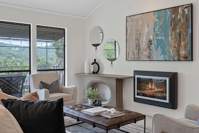 Living room with crown molding, lofted ceiling, a