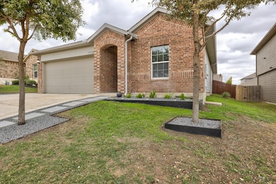 View of front of property featuring a garage, con