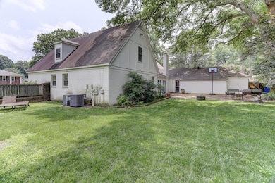 Back of property featuring brick siding, a patio area, cooling unit, roof with shingles, and board and batten siding