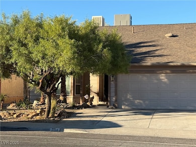 View of front facade featuring concrete driveway and a garage