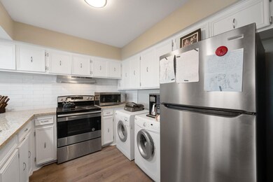 Kitchen featuring washer and dryer, stainless ste
