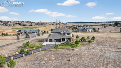 Back of property featuring driveway and a residential view
