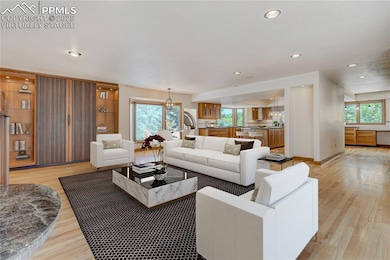 Living area with light wood-type flooring, virtually staged recessed lighting, and healthy amount of natural light