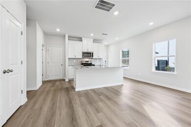 Kitchen featuring visible vents, an island with si