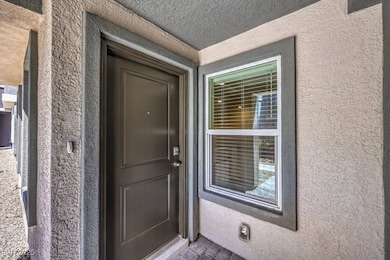 Entrance to property featuring stucco siding