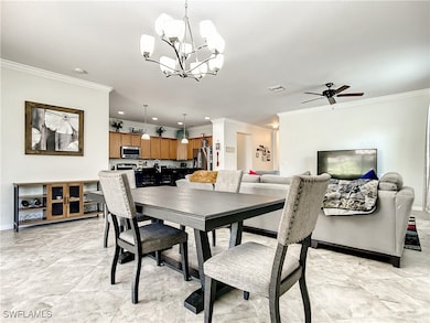 Dining area featuring crown molding, a chandelier,
