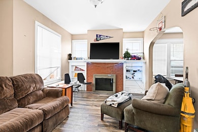 Living room with a fireplace and wood finished flo