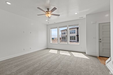 Spare room with light carpet, ceiling fan, and recessed lighting