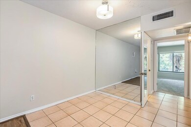 Unfurnished room featuring light tile patterned f