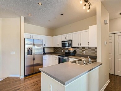 The kitchen has hardwood floors, stainless appliances and a great backsplash.