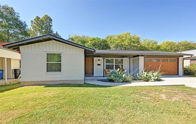 View of front of home featuring brick siding, a p