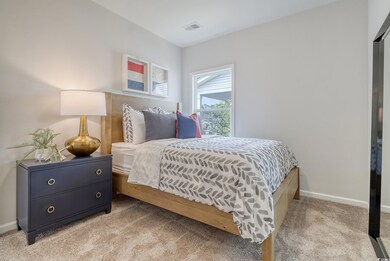 Bedroom with light carpet and baseboards