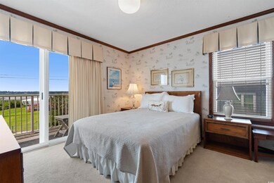 Bedroom featuring access to outside, light carpet,