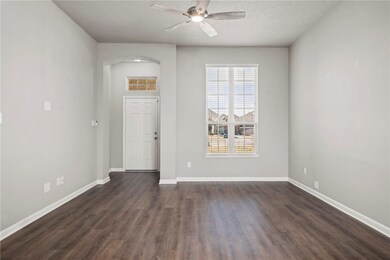 Entrance foyer with a textured ceiling, dark wood-
