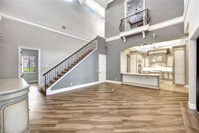 Unfurnished living room featuring a high ceiling, 
