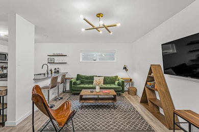 Living room featuring baseboards, wood finished f