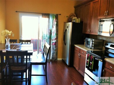 Kitchen leads to back yard.