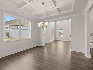 Westerly dining room with a window and open to the two-story foyer